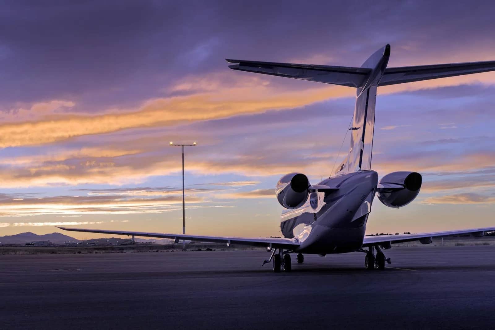 Private jet on the apron at sunset
