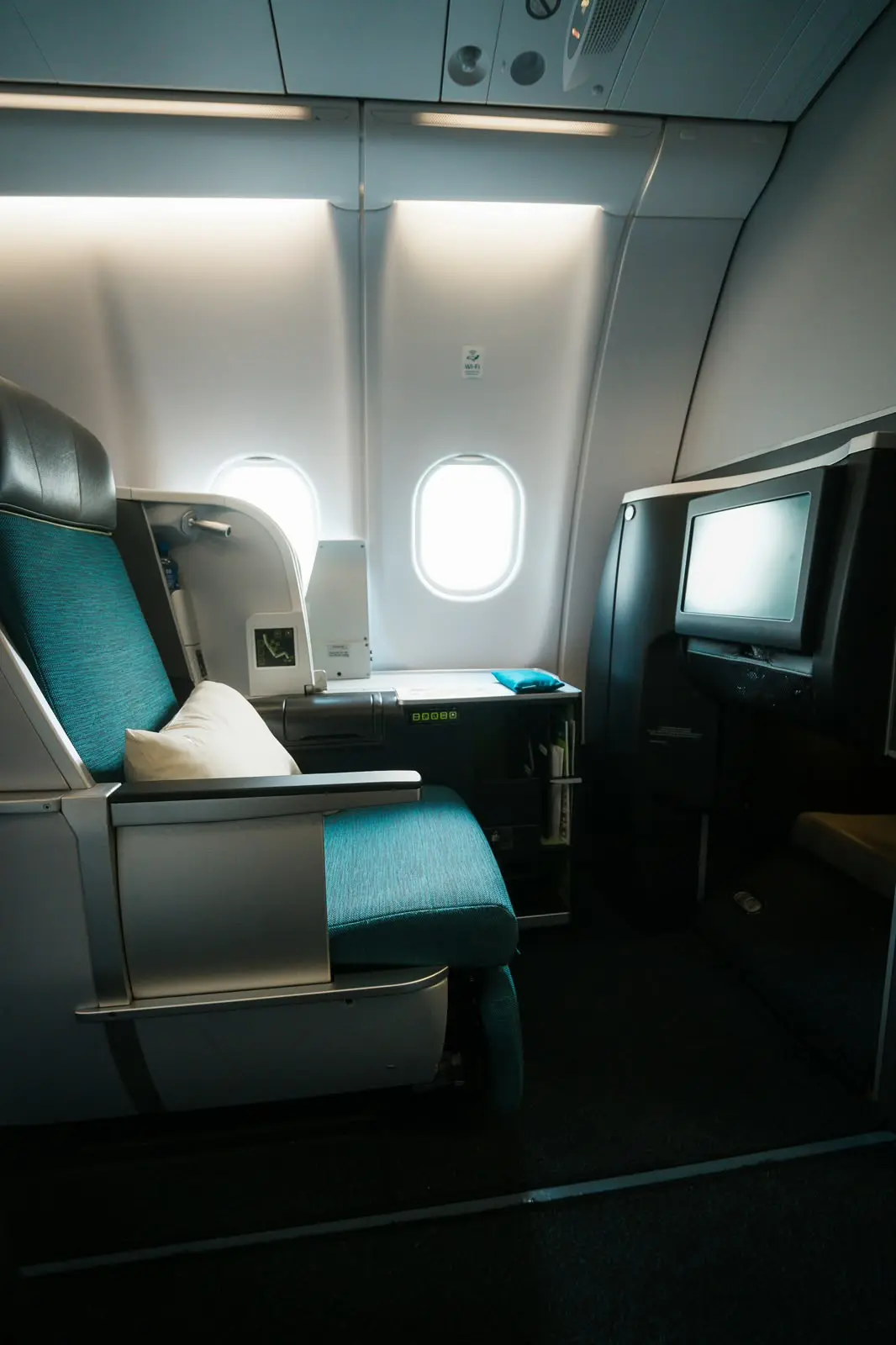 Business class seat by the window in an airliner cabin